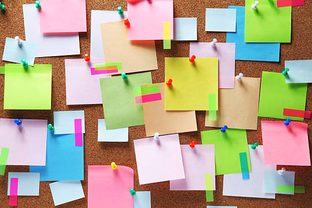 Image of colorful sticky notes on cork bulletin board stock photo