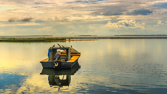 Crab boat on Apalachicola Bay, Florida. Beautiful sunny morning with clouds and water.