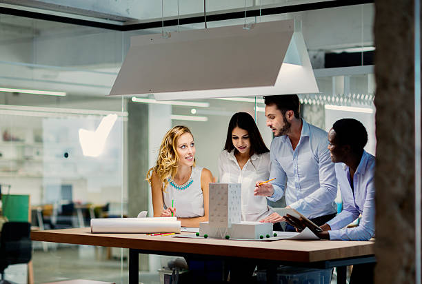 istock Multiethnic Team of architects reviewing architectural model in the office. 468574680