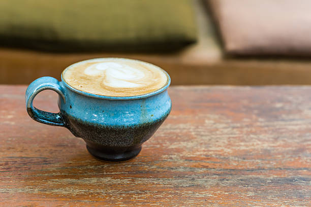 istock ceramic cup of hot coffee on wooden table. 468575836