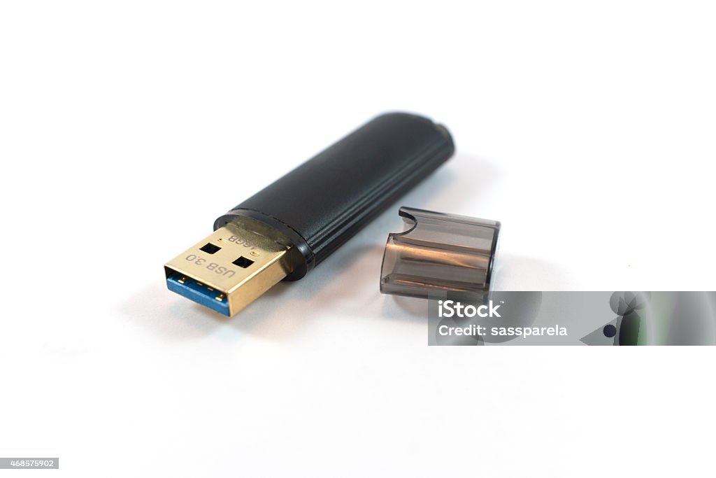 USB flash drive. Black USB flash drive isolated on a black background, with the cap off. 2015 Stock Photo