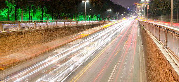 istock High speed and blurred bus light trails in downtown nightscape 468576482