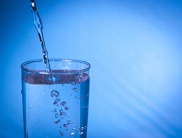 istock pouring water in glass 468578902