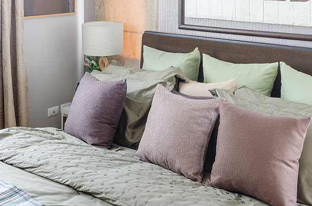 istock pillows on king size bed with modern white lamp 468579360