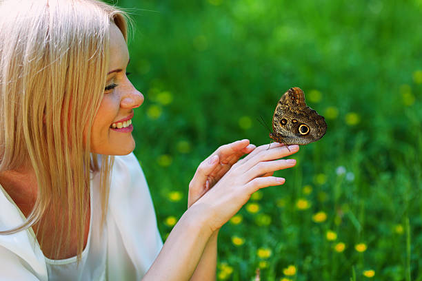 istock Woman playing with a butterfly 468582100