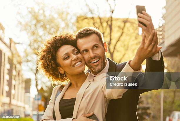 Happy Elegance Adult Couple Talking Selfie Outdoor Stock Photo - Download Image Now - 2015, Adult, Adults Only