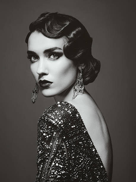 Glam retro diva Studio portrait of beautiful glamourous  woman wearing shiny dress. 20's - 30's styled image. Professional make-up and hairstyle. High-end retouch. actress headshot stock pictures, royalty-free photos & images