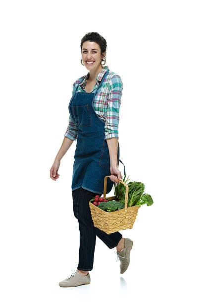 istock Cheerful farmer walking with vegetable basket 468583227