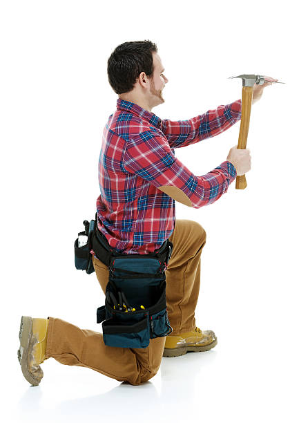 istock Carpenter in action with hammer and nail 468583585