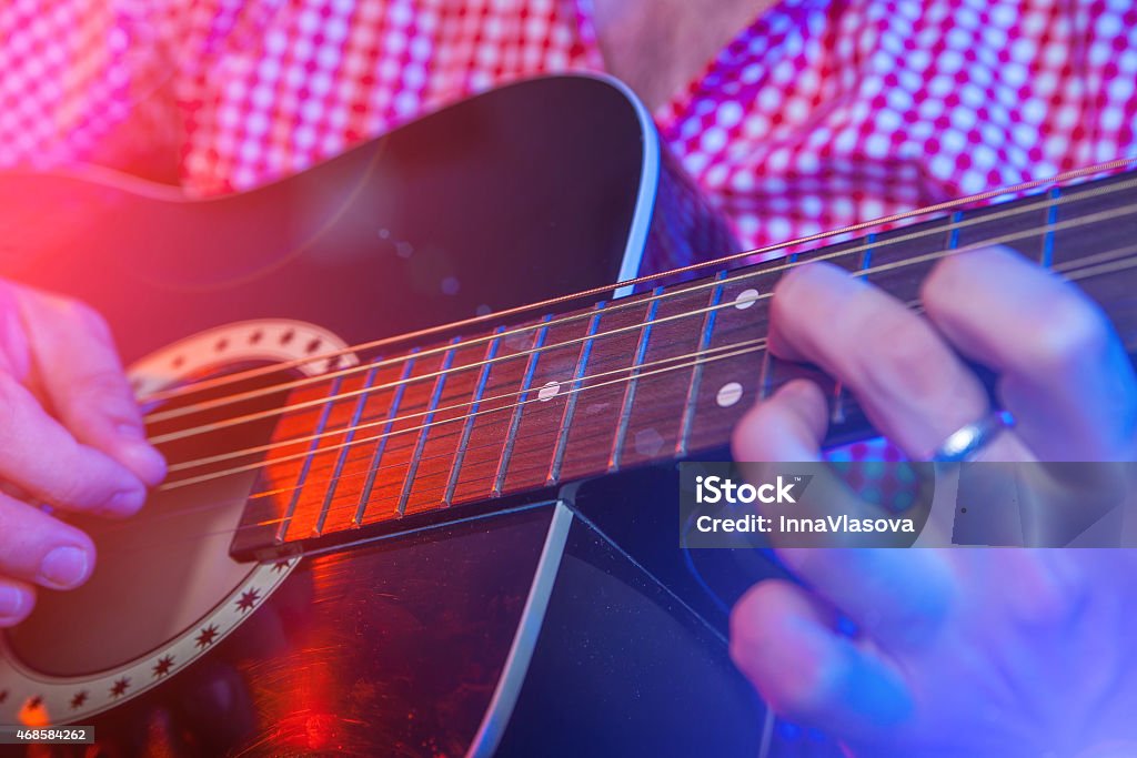 Male Musician with a acoustic Guitar Rockstar Playing Live solo on Guitar 2015 Stock Photo