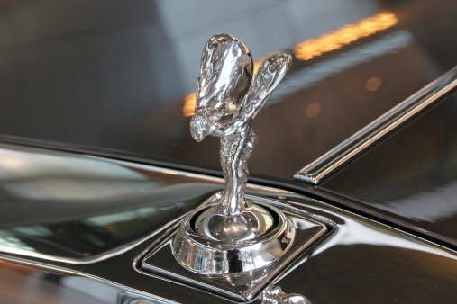 Munich, Germany - February 6, 2014: The Spirit of Ecstasy or top (hood) ornament. Rolls Royce car in an exhibition in munich. The Spirit of Ecstasy is one of the most well known motor car mascot in the world. Designed by Charles Robinson Sykes, The Spirit of Ecstasy has adorned the radiators of Rolls-Royce motor cars since 1911. This wonderful mascot was modeled after a young woman who had bewitching beauty, intellect and esprit - but not the social status which might have permitted her to marry the man with whom she had fallen in love.