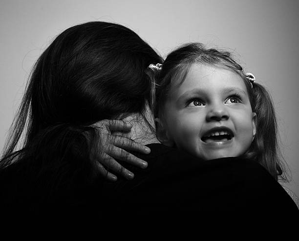 istock Mother and smiling enjoying daughter hugging 468586542