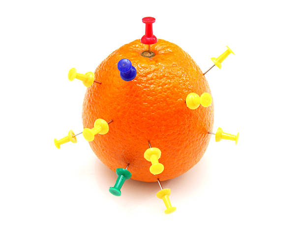 istock Isolated colourful office pins thrust in an orange 468588264