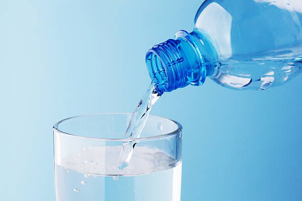 istock Pouring water into glass 468588356