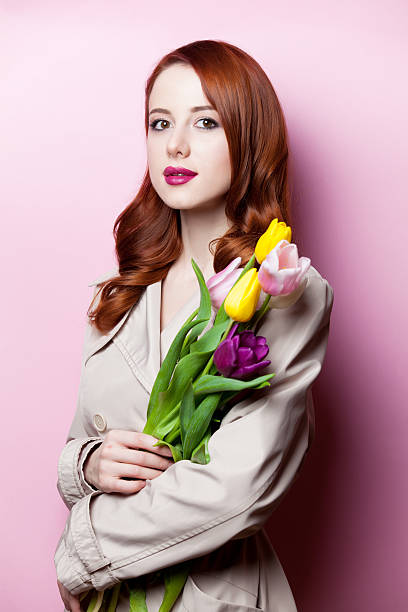 istock beautiful redhead girl with flowers 468590300