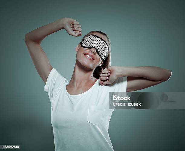 Smiling Young Woman Wearing Sleeping Mask On Her Eyes Stock Photo - Download Image Now