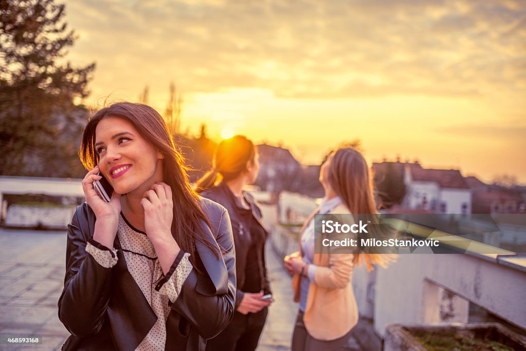 Happy friends enjoy outdoors Happy friends enjoy outdoors with mobile phone 2015 Stock Photo