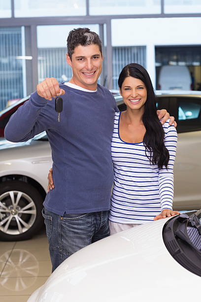 istock Smiling couple holding their new car key 468594174