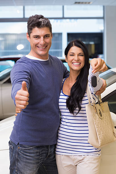 istock Smiling couple holding their new car key 468594214
