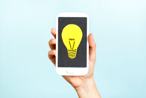 Hand showing a phone concept with a bulb on blue background