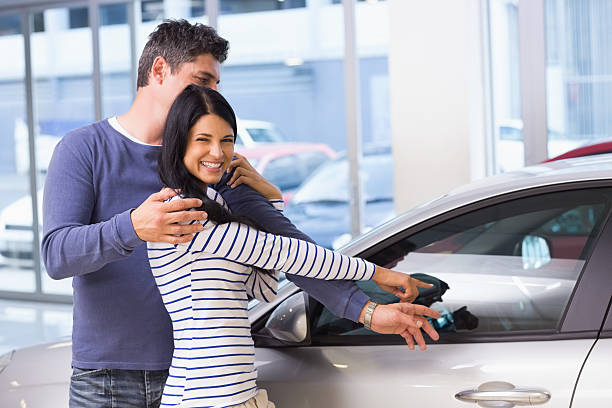 istock Smiling woman presenting her new car 468594622