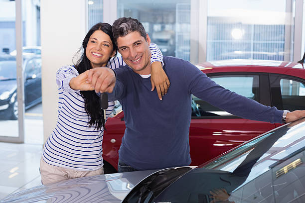 istock Smiling couple holding their new key 468594764