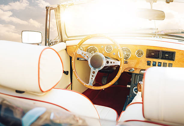 istock Oldtimer convertible car steering wheel and cockpit against sunny sky 468594832