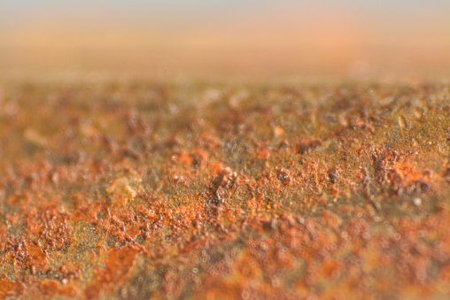 Rusty and decayed steel barrel close up