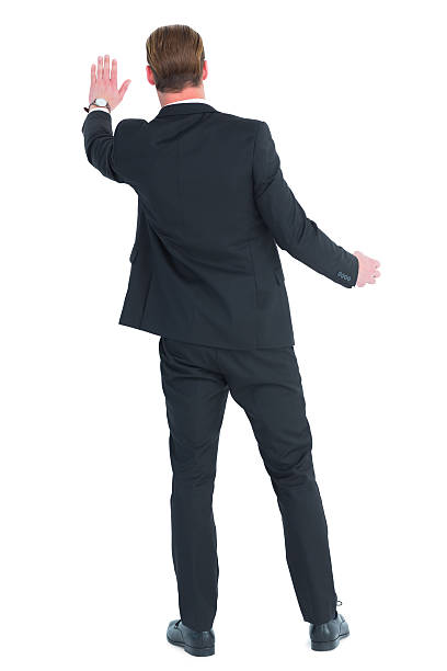 istock Rear view of businessman in suit gesturing 468595232