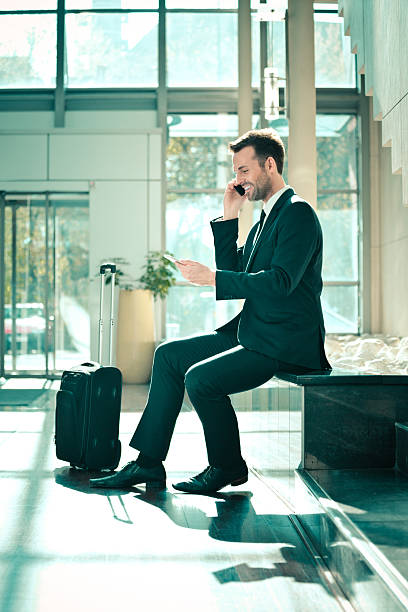 istock Businessman talking on cell phone in hotal hall 468595240