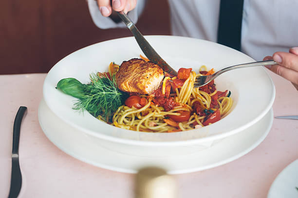 istock Businessman on lunch break eating pasta 468595252