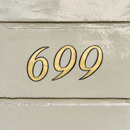 gold colored house number six hundred and ninety nine