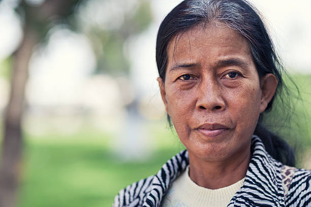 Portrait of a cambodian woman Natural portrait of cambodian woman in her late middle age (60+). cambodian ethnicity stock pictures, royalty-free photos & images