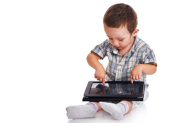 istock Baby toddler pointing at a digital tablet 468600796