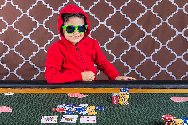 istock Young boy playing poker at a table 468602658