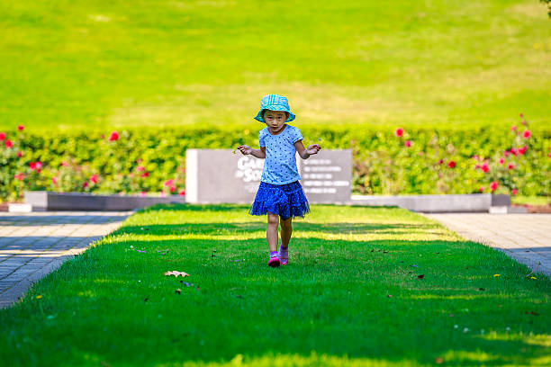 Adorable Girl Little girl having a good time in the garden people walking png stock pictures, royalty-free photos & images