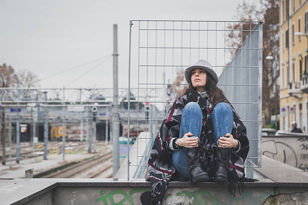 istock Beautiful young brunette posing in the city streets 468608220