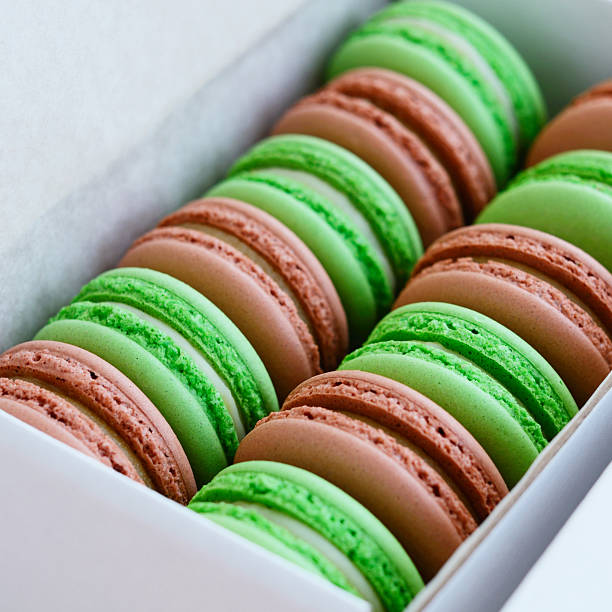 istock Set of pistachio and caramel macaroon in white box, square 468608384
