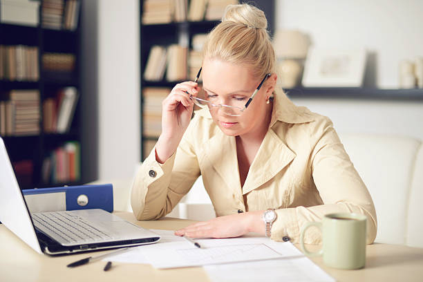 istock blonde woman working at home 468608850