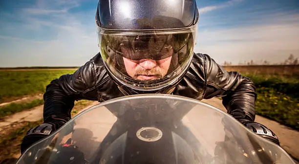 Photo of Biker racing on the road