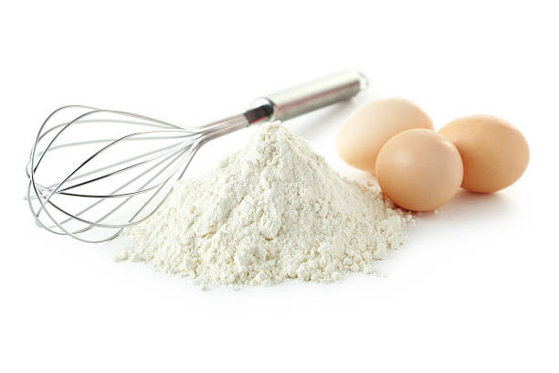 istock Heap of wheat flour with eggs and whisk 468615204