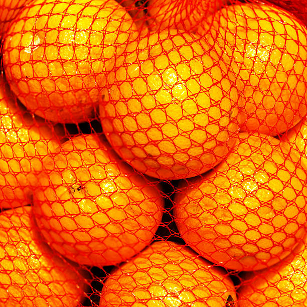 istock Bunch of fresh  Orange fruits in a string bag 468615948