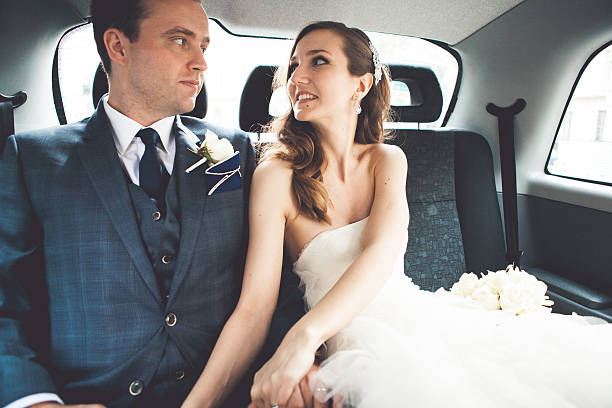 istock Bride and groom in a car 468624128
