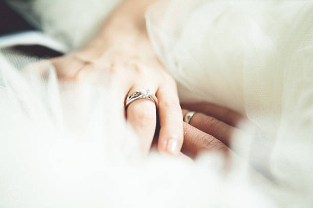 A picture of a bride and groom holding hands For more wedding photos, please visit the lightbox below: chinese wedding dress stock pictures, royalty-free photos & images