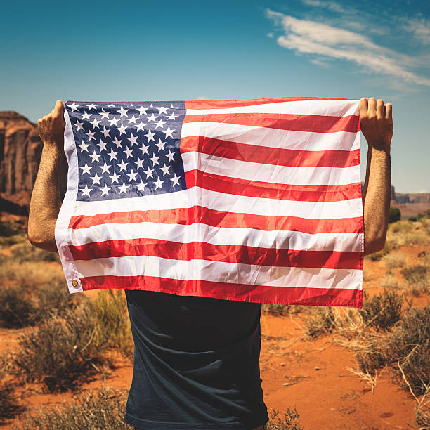 istock Tourist with flag on Monument valley National park 468628197