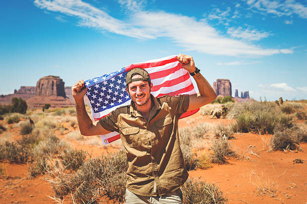 istock Tourist on the Monument valley with US flag 468628207