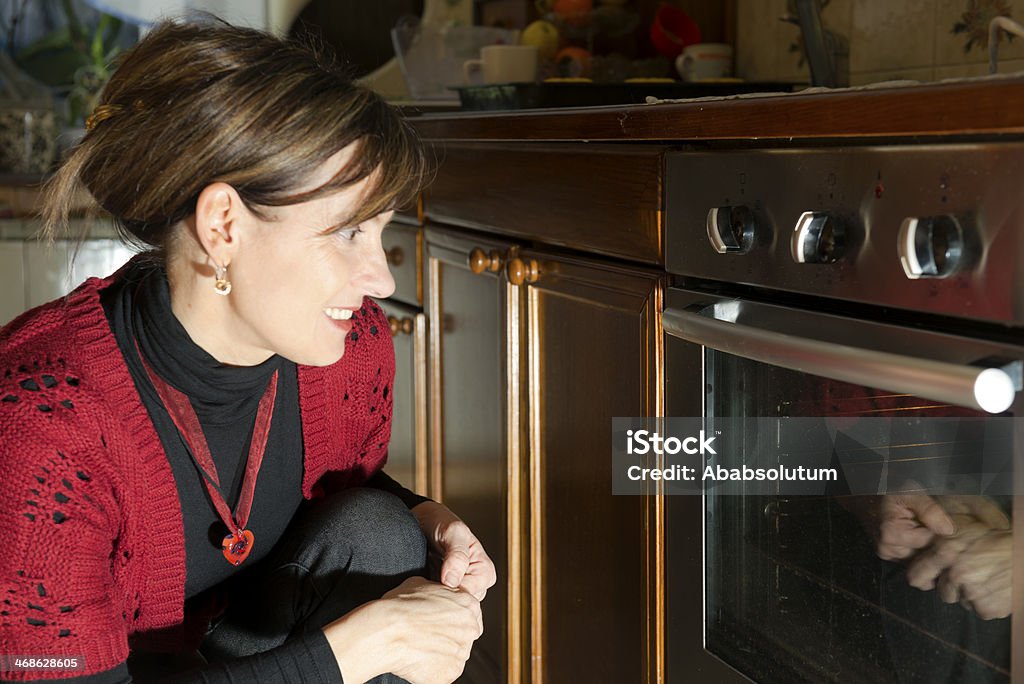 Baking at Home, Slovenia, Europe Woman baking in a domestic kitchen, Slovenia, Europe. Focus on hands. 40-44 Years Stock Photo