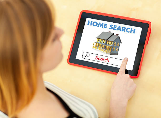 istock Young Woman Using Digital Tablet Computer for House Hunting 468628999