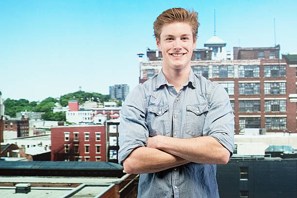 istock Smiling man standing in front of city 468629901