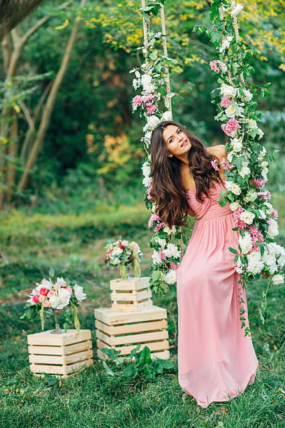 Beautiful young girl on a swing